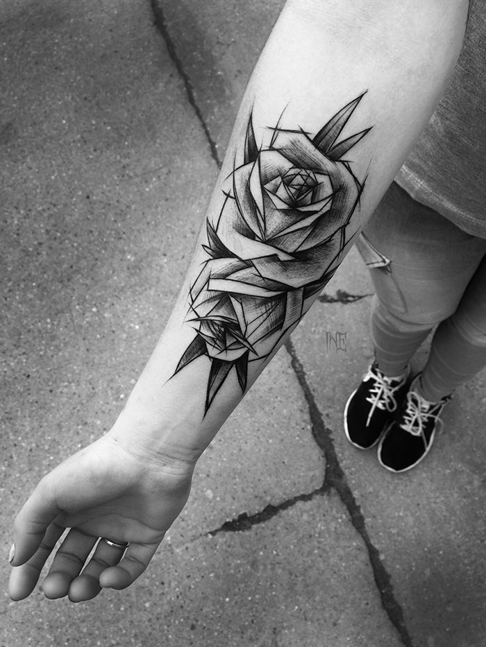 Sketch tattoo of abstract roses on a person's forearm, showcasing the beauty of imperfection.
