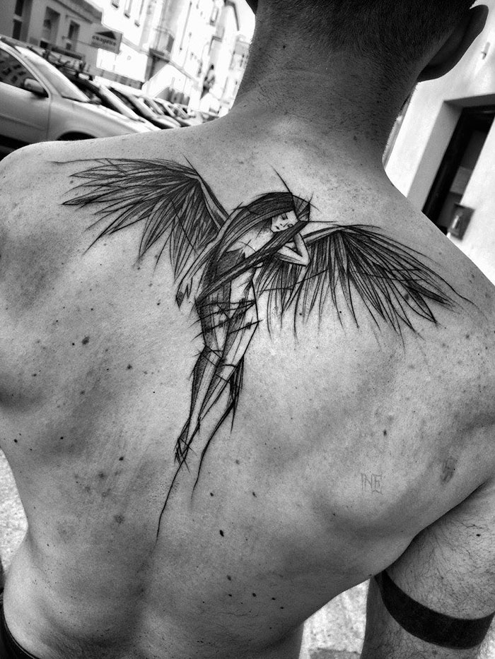 Sketch tattoo of a winged figure on a person's back, showcasing beauty through imperfection by a Polish tattoo artist.