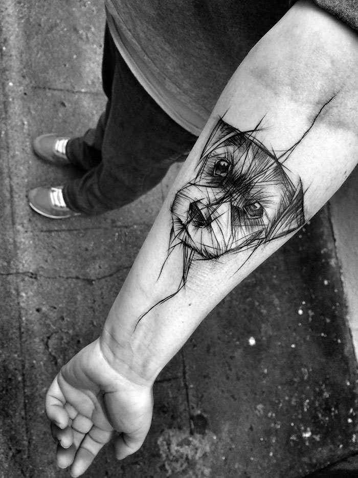 Sketch tattoo of a dog's face on a person's forearm, showcasing the beauty of imperfection by a Polish tattoo artist.