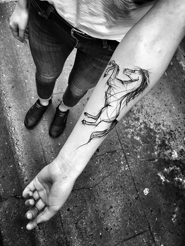 Sketch tattoo of a horse on forearm by Polish artist, showcasing the beauty of imperfection.