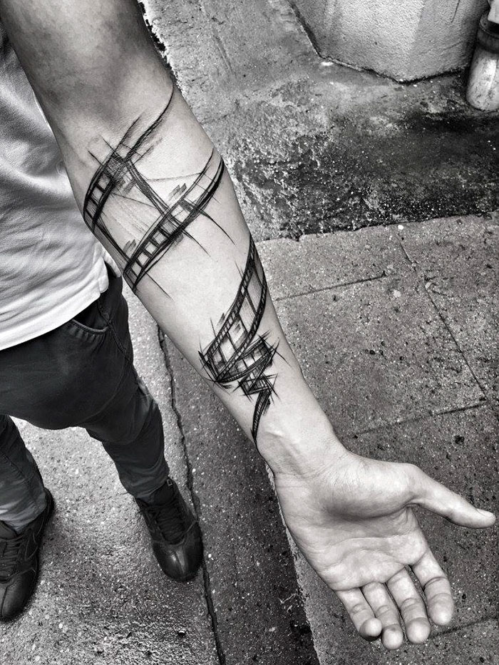 Sketch tattoo of abstract lines on a forearm, showcasing beauty of imperfection by a Polish tattoo artist.