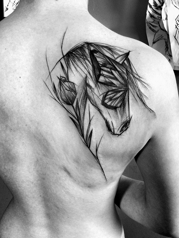 Sketch tattoo of a horse on a person's shoulder, showcasing the beauty of imperfection by a Polish tattoo artist.
