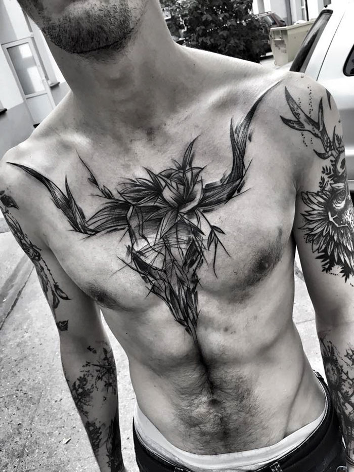 Detailed sketch tattoos on a man's upper body, showcasing the beauty of imperfection by a Polish tattoo artist.