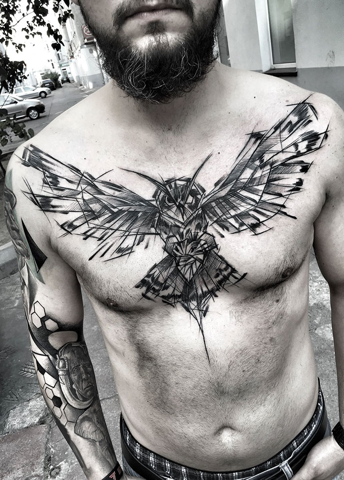Sketch tattoo of an abstract owl design on a man's chest, showcasing the beauty of imperfection by a Polish artist.