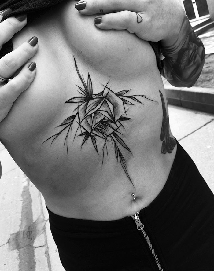 Sketch tattoo by Polish artist on ribcage, showcasing beauty in imperfection with geometric design.
