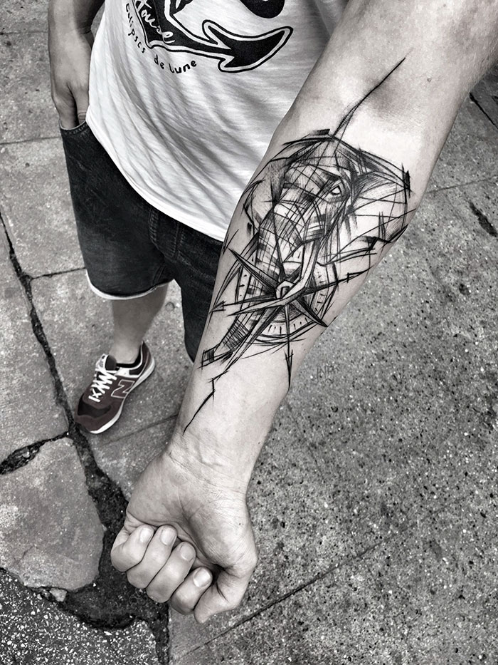 Arm with abstract sketch tattoo, showcasing the beauty of imperfection by a Polish tattoo artist.