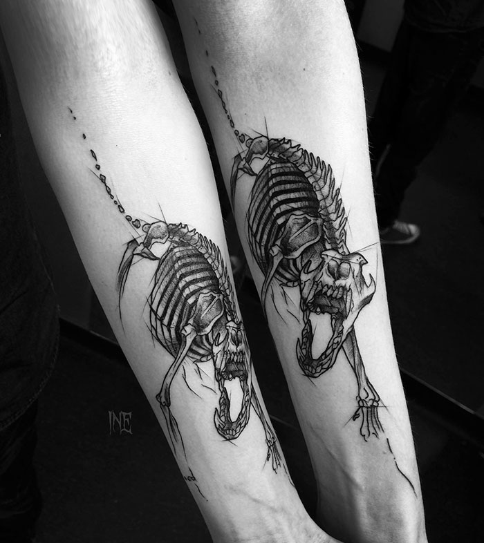 Sketch tattoo of two skeletal animals on forearm, showcasing beauty of imperfection by Polish tattoo artist.