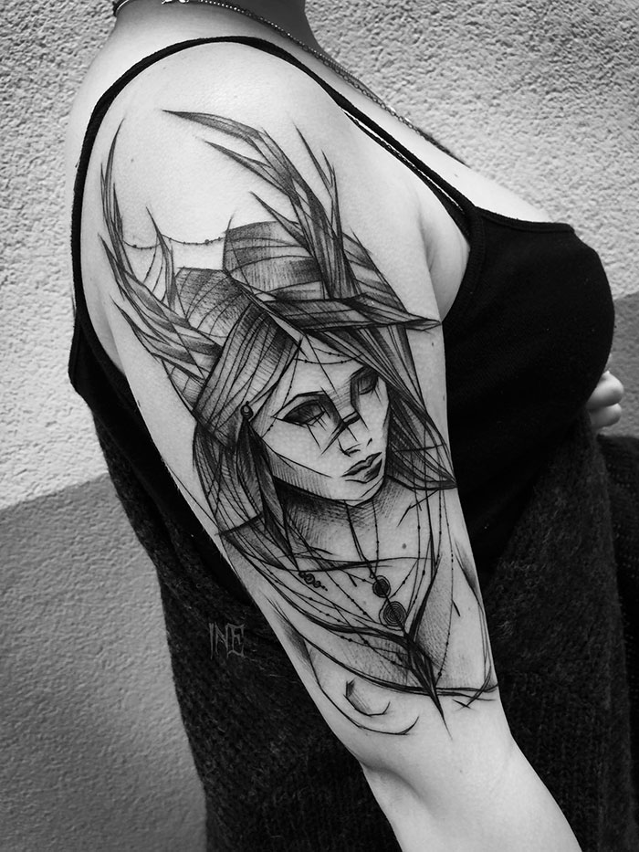 Sketch tattoo by Polish artist on an upper arm, showcasing beauty in imperfection with abstract lines.