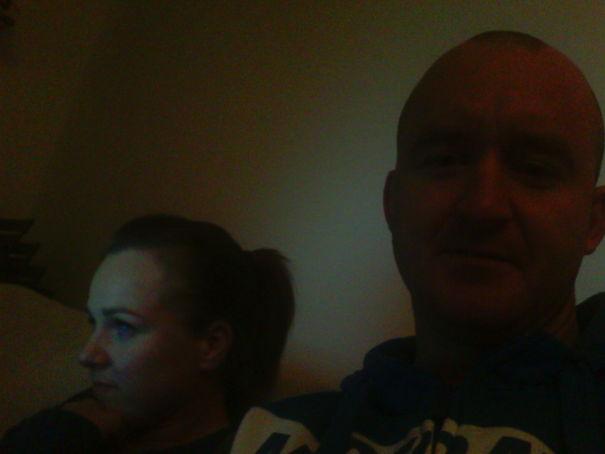 Man and woman sitting indoors with dim lighting, illustrating before-and-after pics of what happens when you stop drinking.