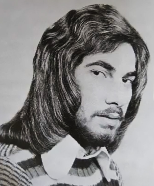 Vintage men's hairstyle with long, flowing hair from the 1960s and 1970s era.