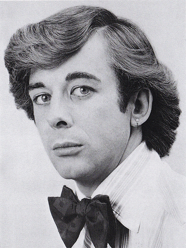 Man with a vintage 1960s hairstyle, wearing a bow tie and striped shirt.
