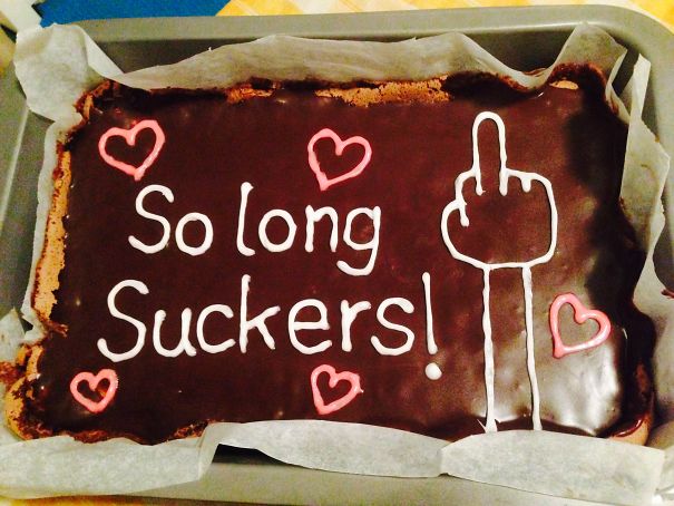 Farewell cake with chocolate icing, decorated with hearts and a humorous message for an employee's last day at the office.