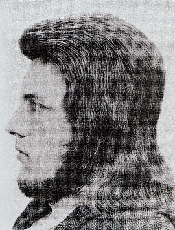 Profile of a man with a voluminous 1960s hairstyle, showcasing iconic romantic men's hairstyles of the era.
