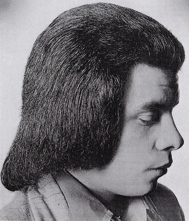 Profile of a man with a distinctive 1970s hairstyle, showcasing romantic men's hairstyles from the era.
