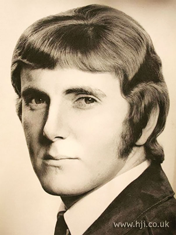 Classic 1960s men's hairstyle with sideburns, styled back and a voluminous top, showcasing popular romantic trends.