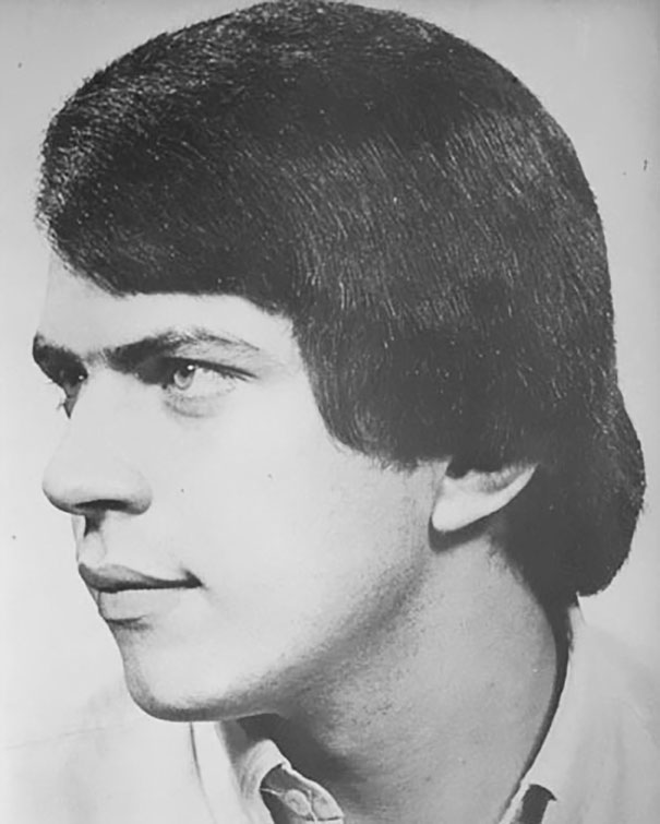 Side view of a man with a classic 1970s hairstyle, showcasing the romantic men's hairstyles of the era.