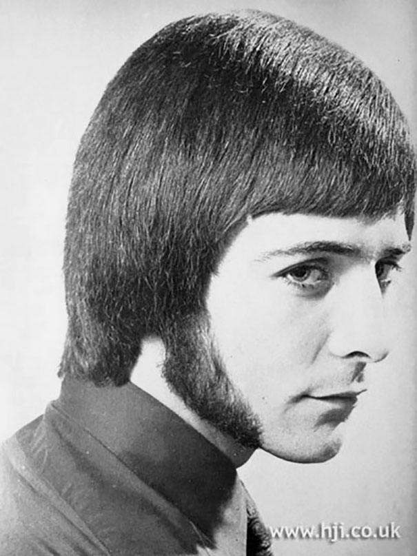 Retro side profile of a man showcasing romantic men's hairstyle from the 1960s and 1970s, featuring sideburns.