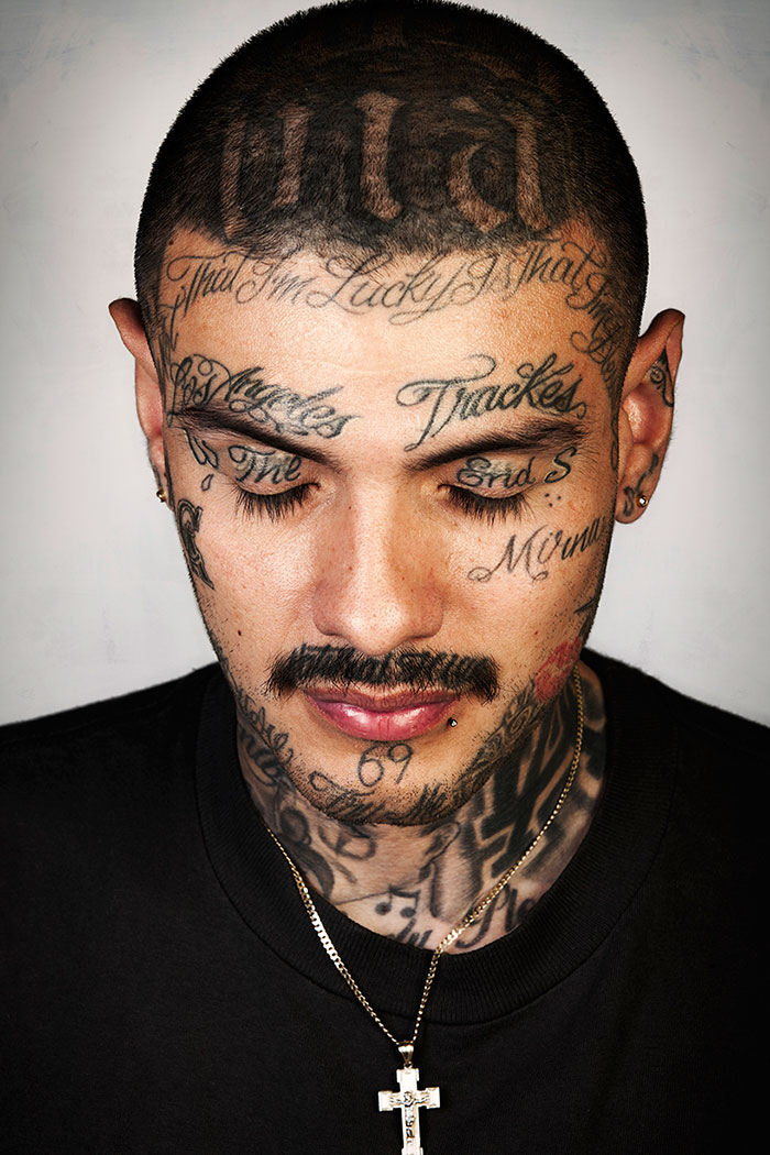 Ex-gang member with prominent face tattoos, showcasing transformation after tattoo removal. Ex-gang member with prominent face tattoos, showcasing transformation after tattoo removal.