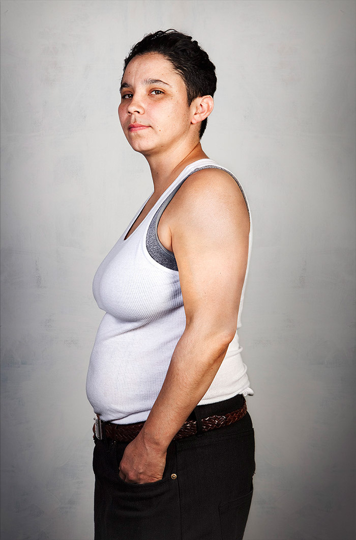 Ex-gang member in a white tank top, tattoos removed, side profile. Ex-gang member in a white tank top, tattoos removed, side profile.