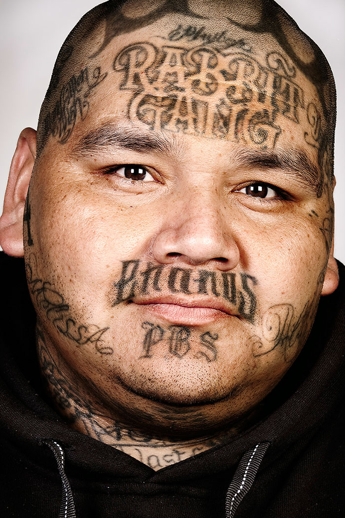 Ex-gang member with facial tattoos in a portrait, highlighting transformative tattoo removal stories. Ex-gang member with facial tattoos in a portrait, highlighting transformative tattoo removal stories.