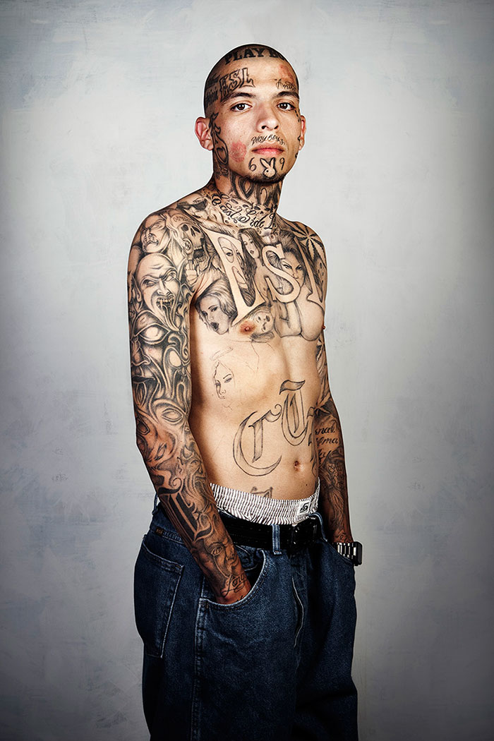 Ex-gang member displaying extensive tattoos prior to removal, showcasing personal transformation journey. Ex-gang member displaying extensive tattoos prior to removal, showcasing personal transformation journey.