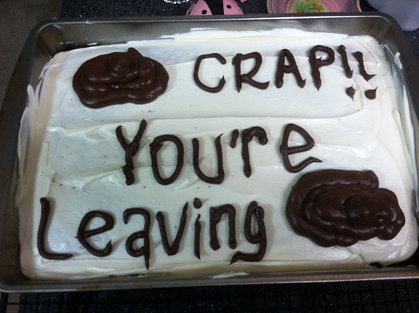 Farewell cake with humorous frosting text, "C**p! You're Leaving" in chocolate icing on white frosting.