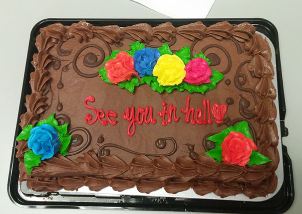 Farewell cake with humorous message "See you in hell" in red icing, decorated with colorful flowers.