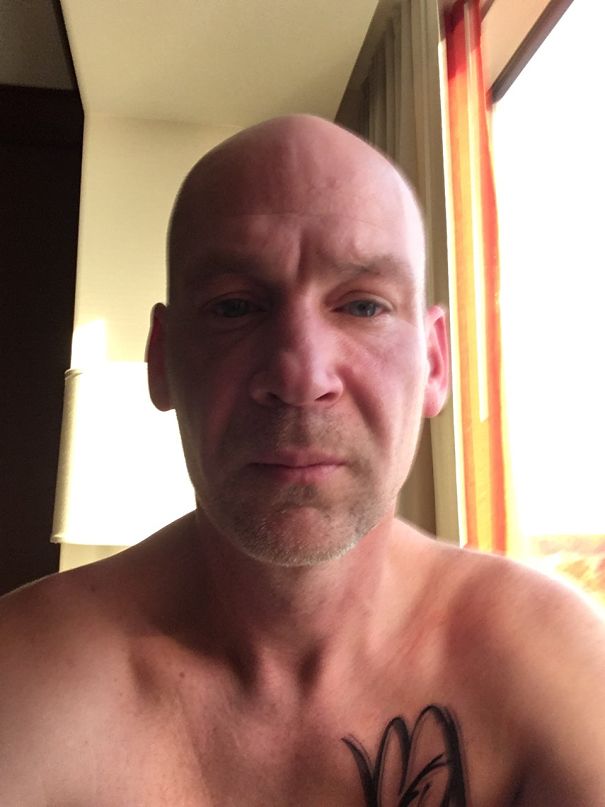 Close-up of a middle-aged man with a tattoo, showing natural skin tone and clarity after quitting drinking.