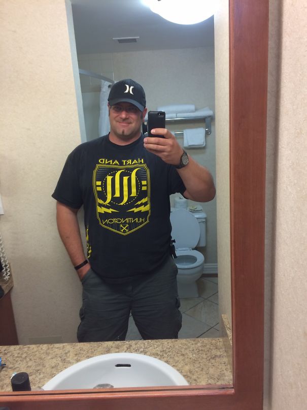 Man taking a bathroom mirror selfie, showing transformation in before-and-after pics when you stop drinking.