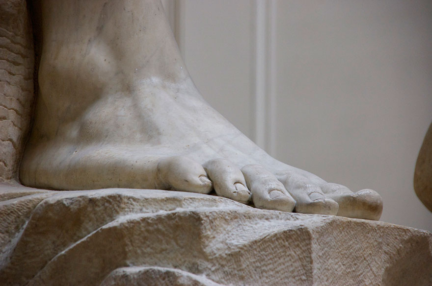 Close-up photography of Michelangelo’s David statue feet.