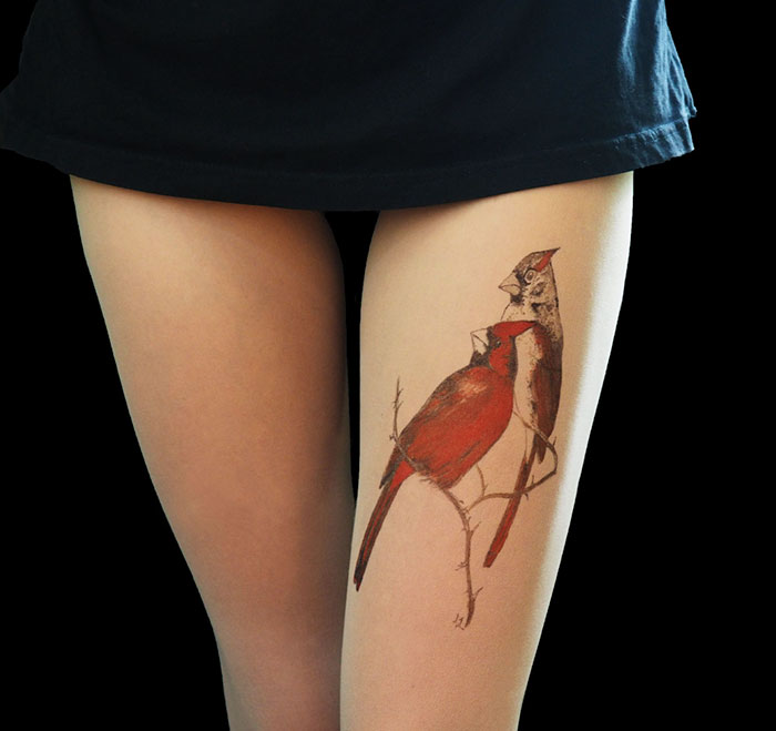 Tattoo tights with bird design, creating an inked leg illusion.