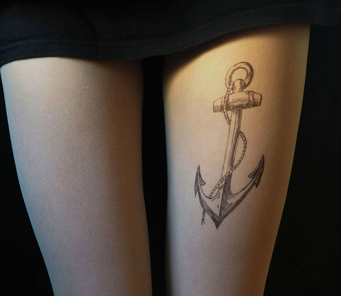 Tattoo tights with an anchor design creating an illusion of a leg tattoo.