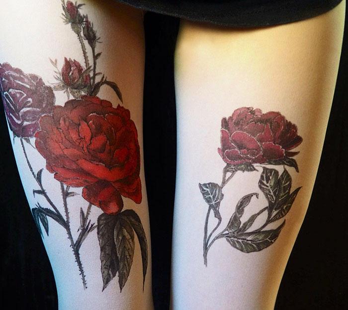 Tattoo tights with red roses creating an inked illusion on legs, providing a trendy and artistic style.