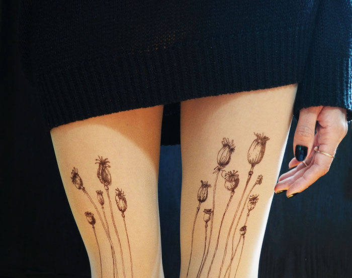 "Tattoo tights with floral design creating the illusion of inked legs under a black dress."