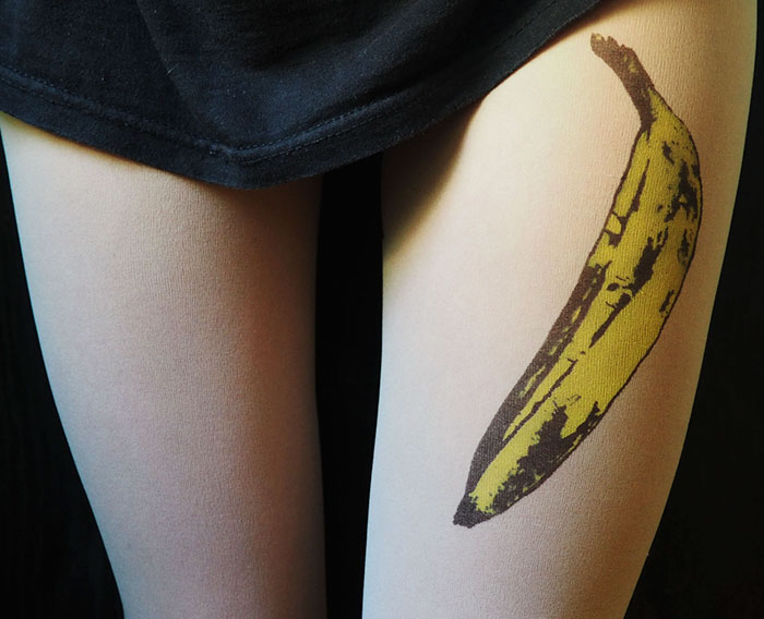 Tattoo tights with a banana design creating an inked illusion on skin-colored fabric.