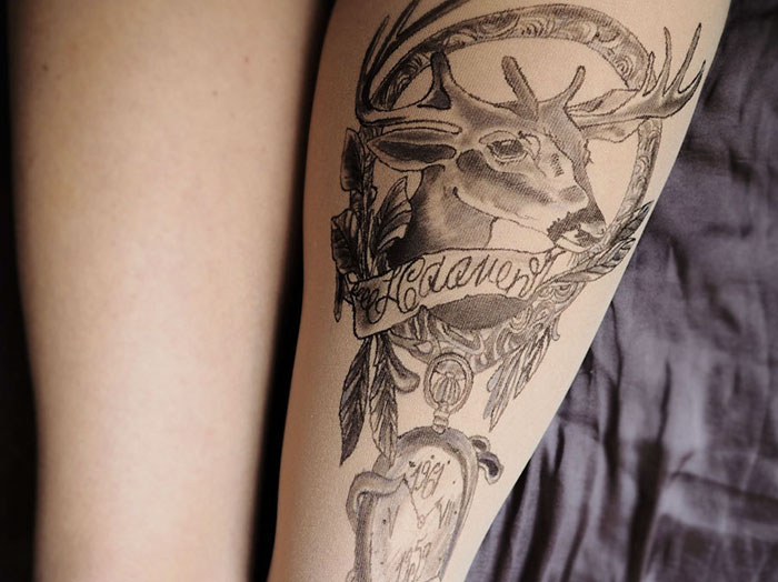 Tattoo tights creating an illusion of an inked deer design on a leg.
