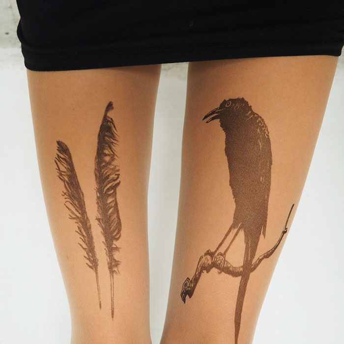Tattoo tights with feather and bird designs creating an illusion of inked legs.
