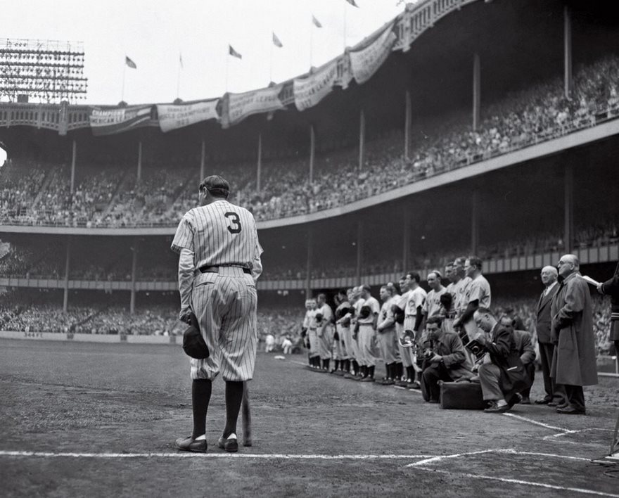 Baseball legend in uniform with number 3, standing on a crowded field during a historic game, symbolizing famous photos in history.