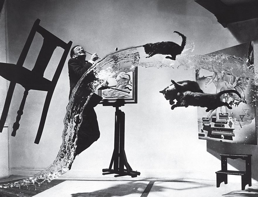 Surrealist scene with a painter, flying cats, water splash, and furniture; one of history's most famous photos.