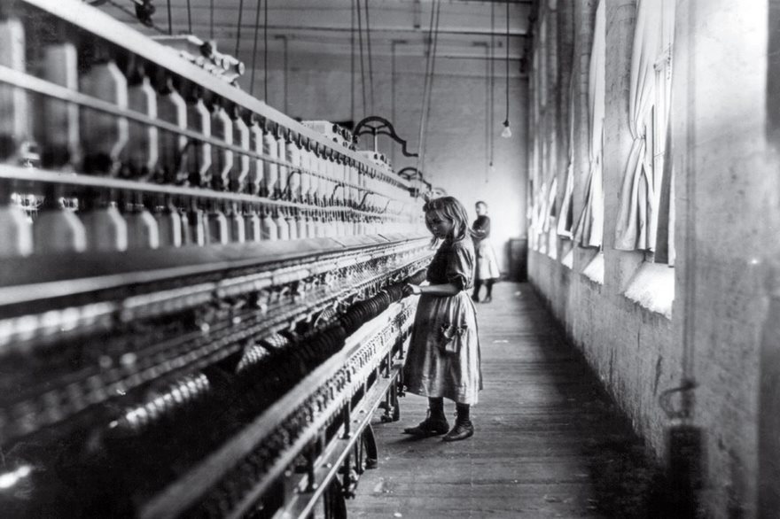 Young girl working in a historic textile mill, illustrating famous photos from history.