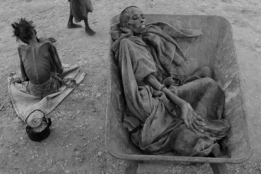 Emaciated individuals in a famine-stricken area, highlighting historical photo's powerful narrative on human suffering.