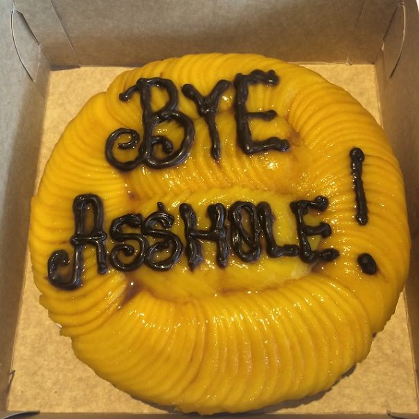 Farewell cake with humorous message in chocolate frosting on top, prepared for an employee's last day at the office.