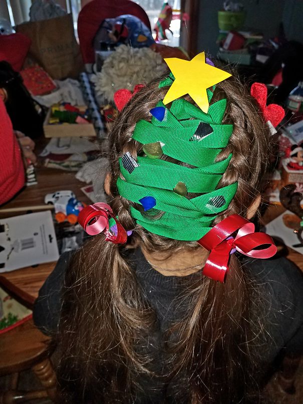 Creative Christmas hairstyle shaped like a tree with ribbons and a star on top.