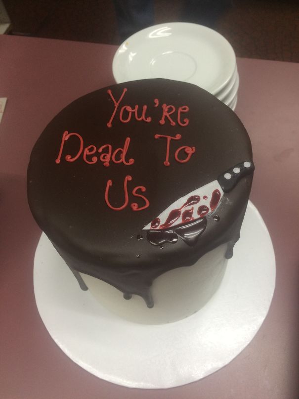 Farewell cake with chocolate icing, decorated with "You're Dead To Us" caption and knife design.