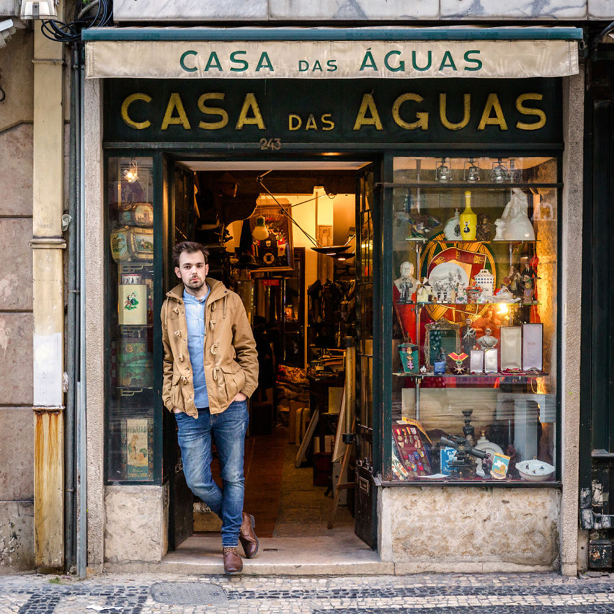 Tiago Veiga, Manager, Poses In Front Of His Shop
