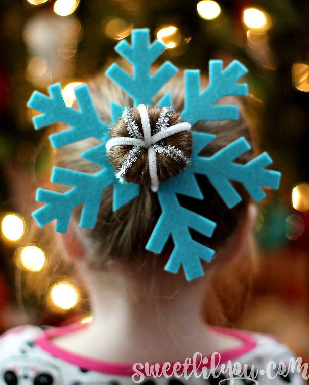 Creative Christmas hairstyle with a snowflake bun accessory, set against festive lights.