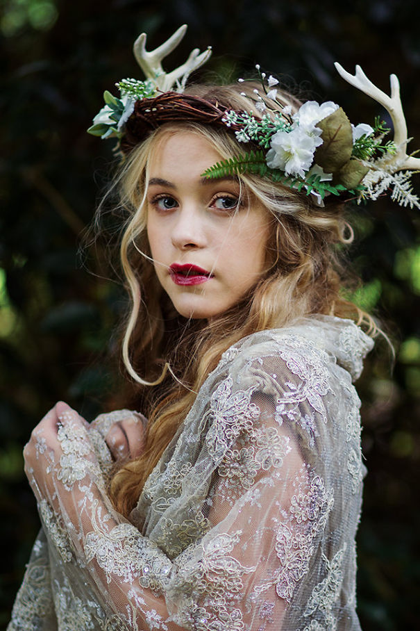 Creative Christmas hairstyle with antler-themed floral crown and lace garment.