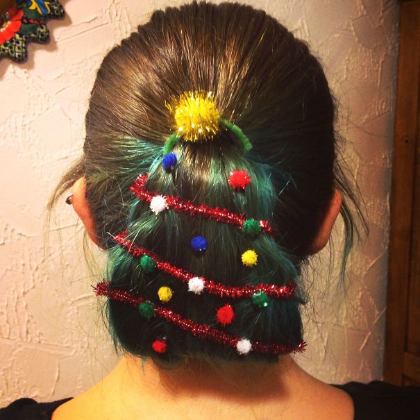 Creative Christmas hairstyle featuring hair shaped like a tree, adorned with colorful decorations and tinsel.