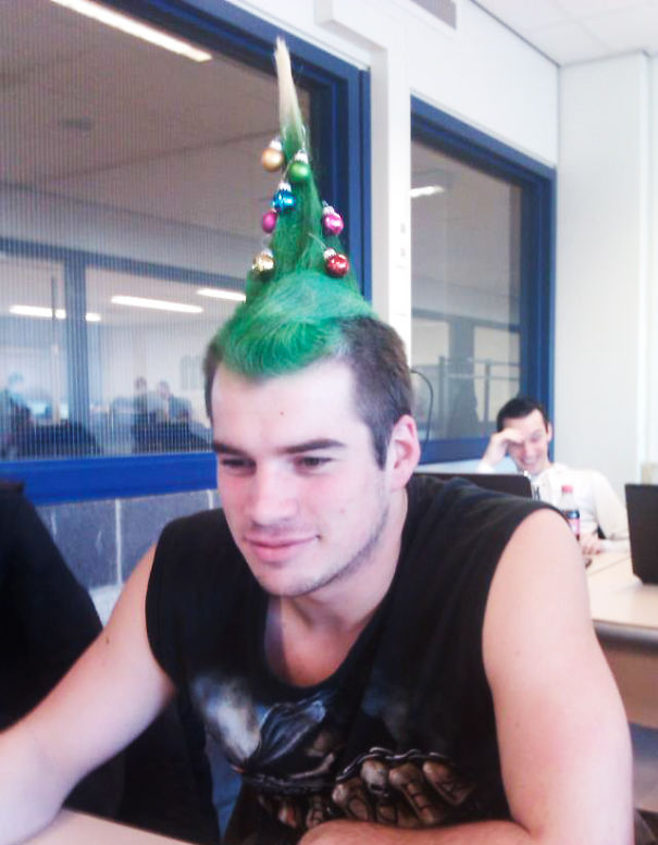 Creative Christmas hairstyle with green, tree-shaped hair adorned with colorful ornaments.