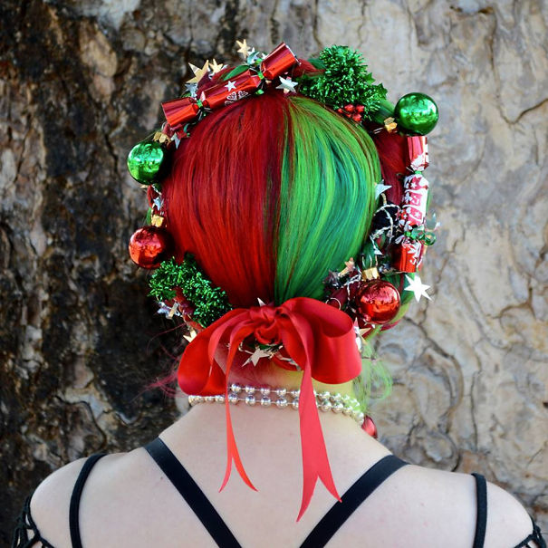 Creative Christmas hairstyle with red and green colors, adorned with ornaments and a red bow.